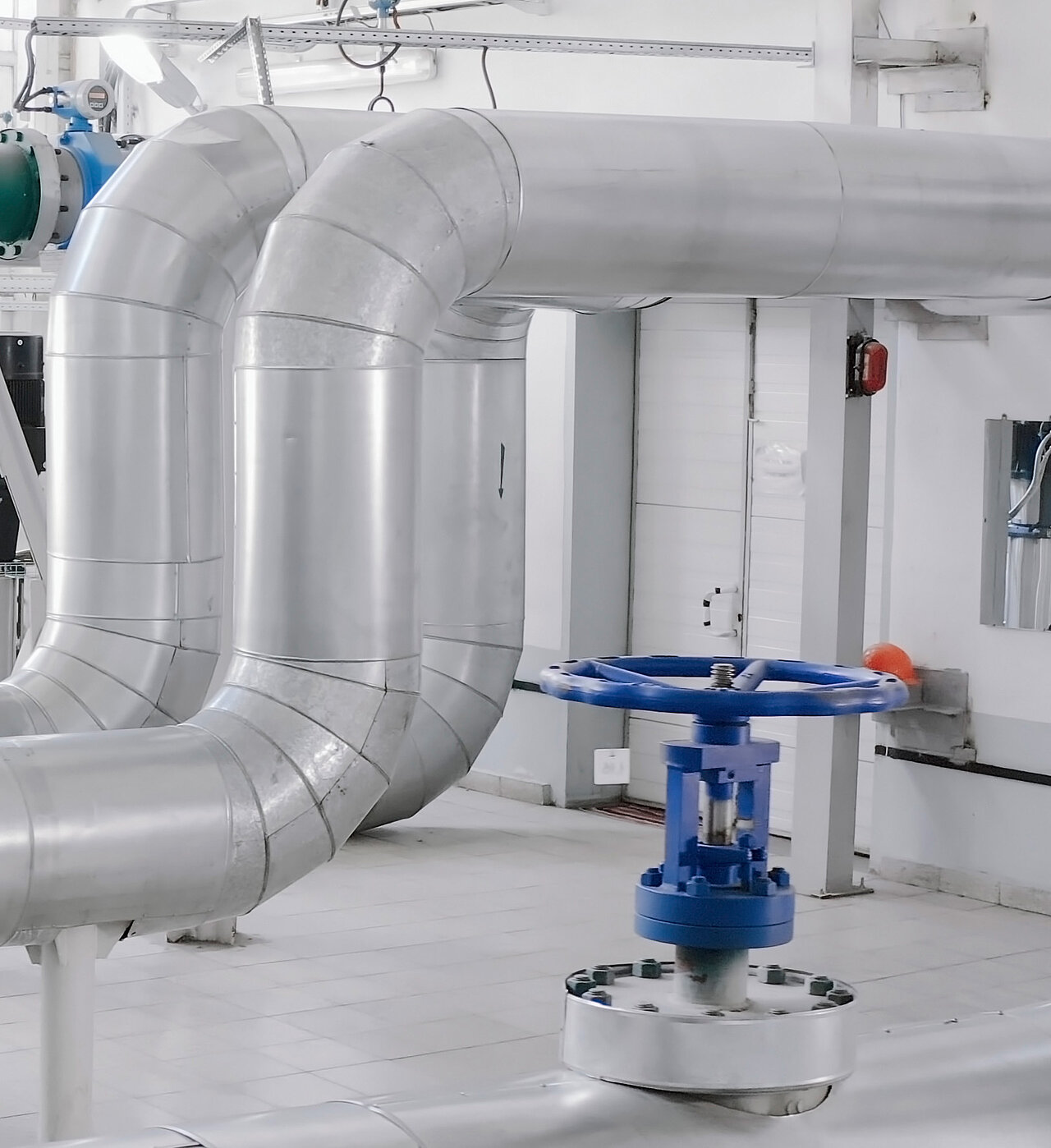 Große Industrierohre und Ventile in einer hellen, sauberen Anlage