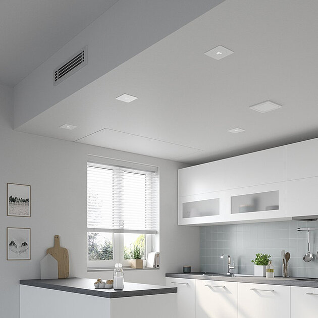 Moderne Küche mit weißen Schränken, grauen Arbeitsplatten und einem Fenster, das natürliches Licht hereinlässt.