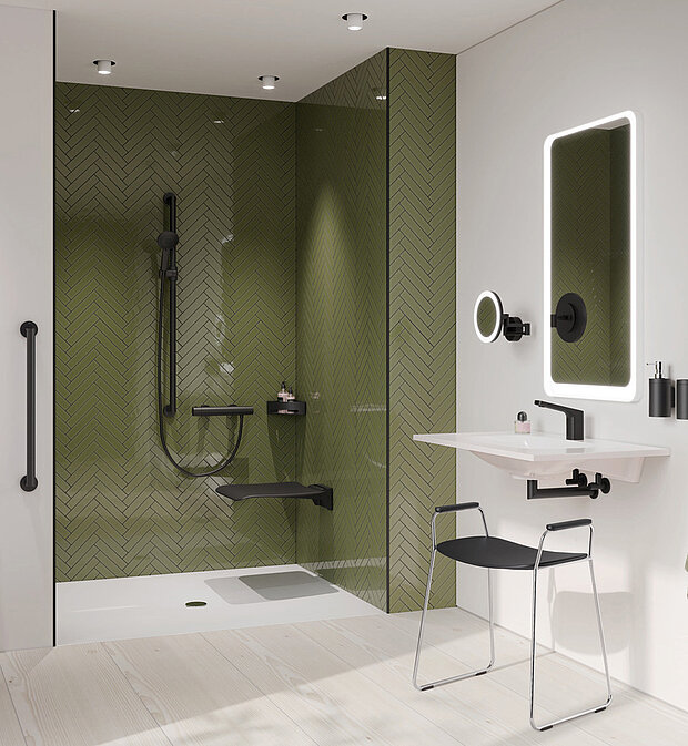 Modernes, barrierefreies Bad mit olivgrün gefliester Dusche, schwarzen Armaturen, klappbarem Duschsitz, Haltegriffen.